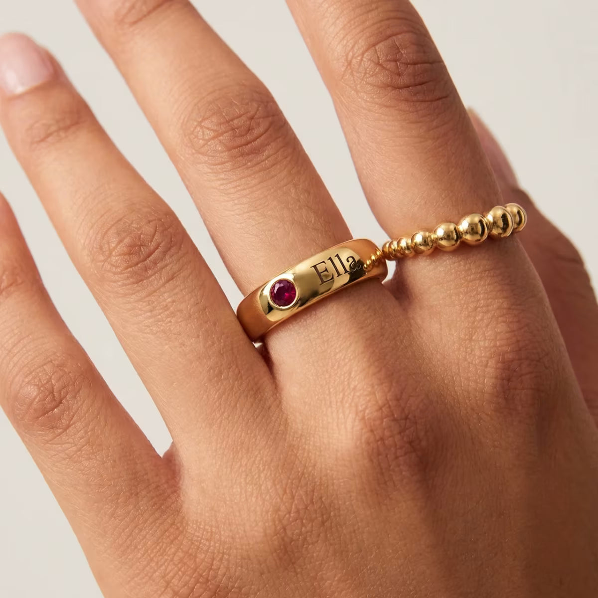 Personalised Name and Birthstone Ring worn on hand showing gold finish