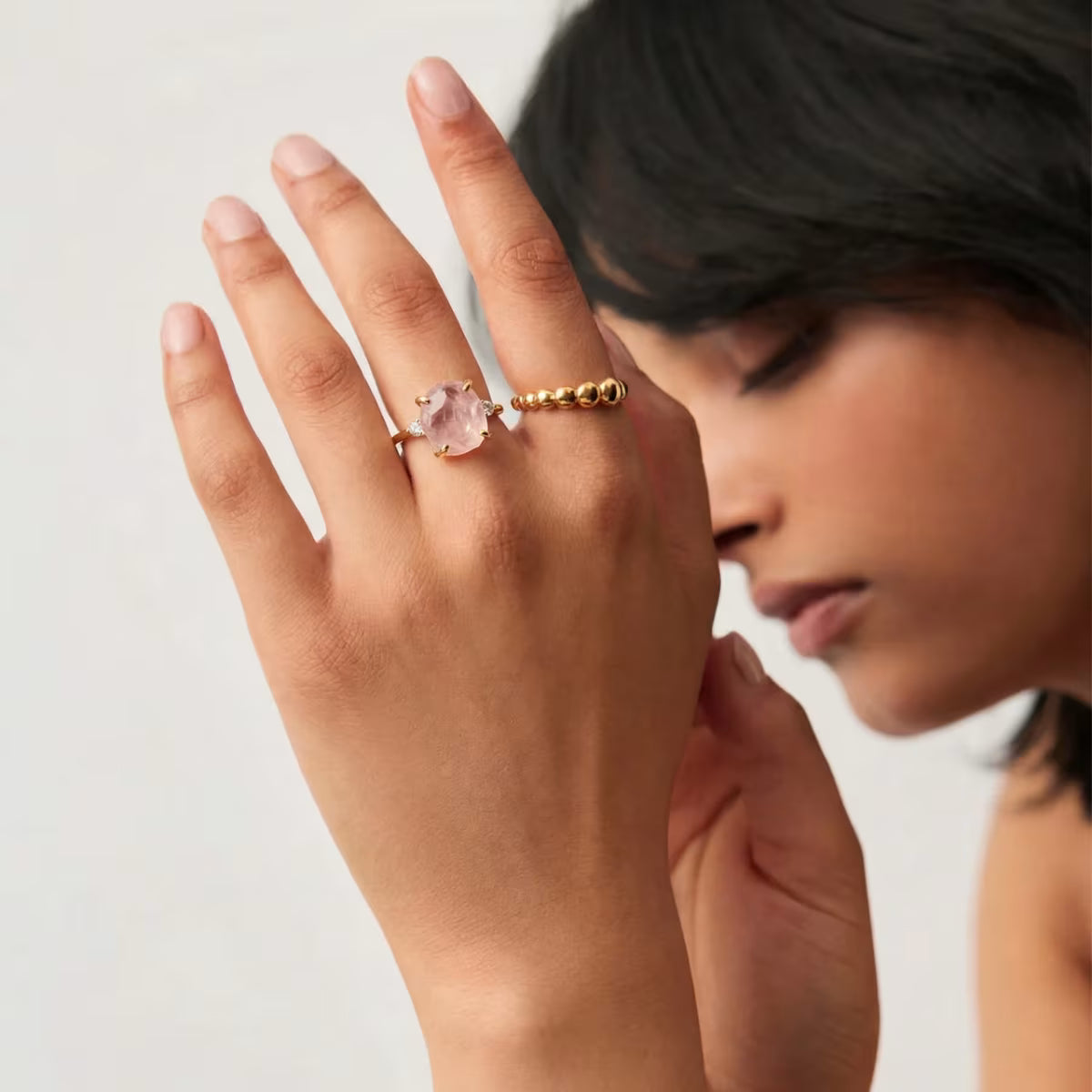 Raw Rose Quartz Ring worn on hand showing gold finish