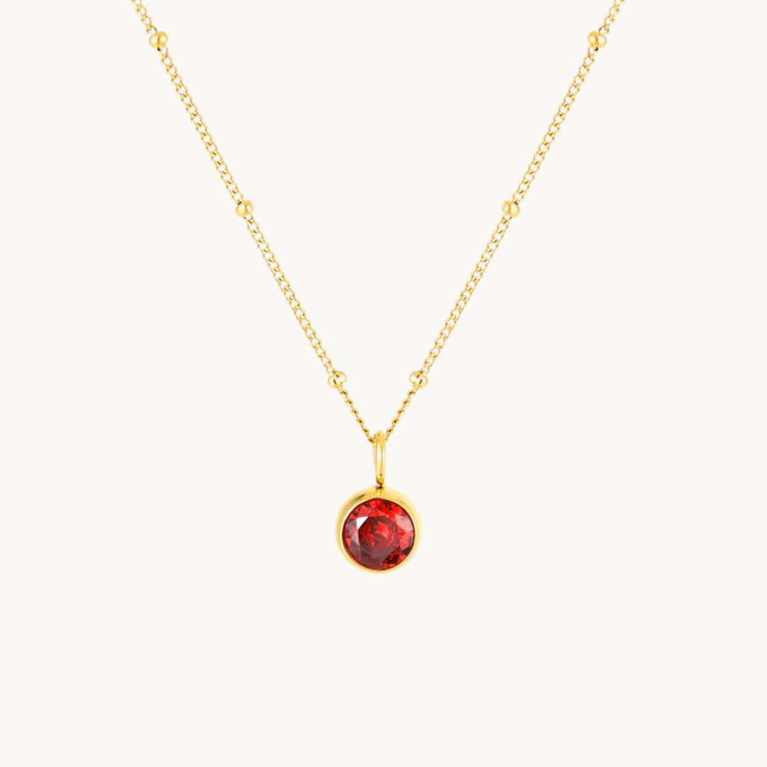 Gold necklace with January birthstone Garnet pendant on white background – Moonela jewelry