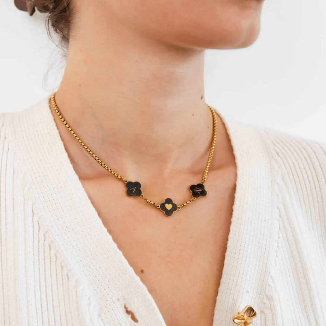 model wearing black enamel clover necklace with engraved initials – minimalist and refined