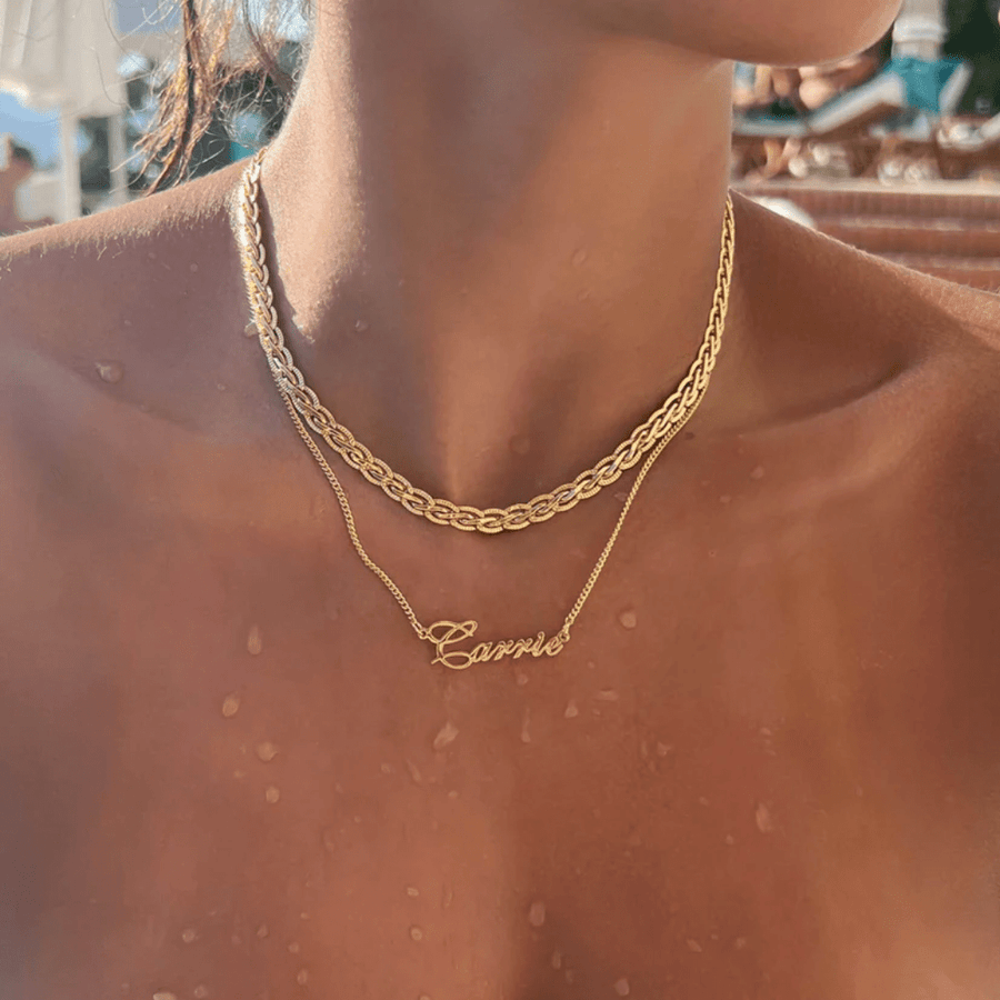 Close-up of gold script font on child name collier showing letter thickness
