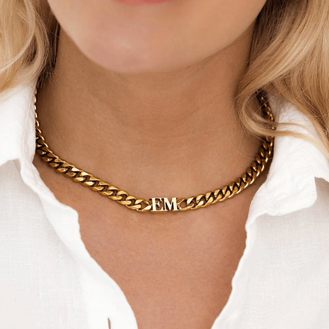 gold curb chain initial necklace worn close to neck – thick and bold style